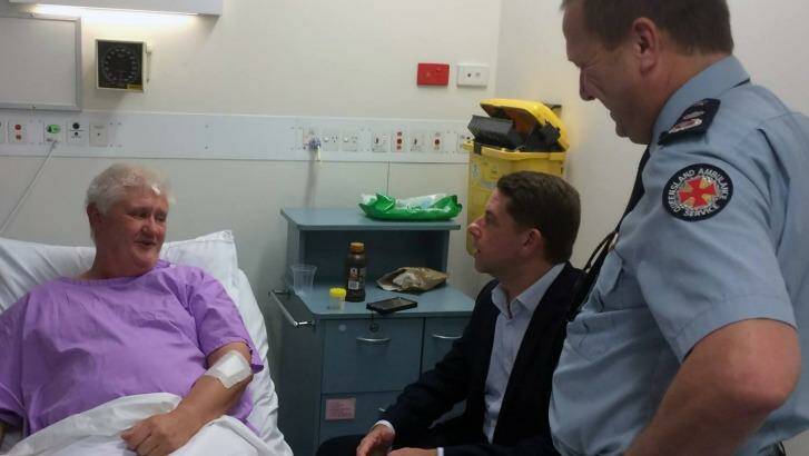 Ambulance Services Minister Cameron Dick and Queensland Ambulance Service Commissioner Russell Bowles visit the injured Fraser Island paramedic in hospital on Saturday. Photo: Queensland Ambulance Service Fac