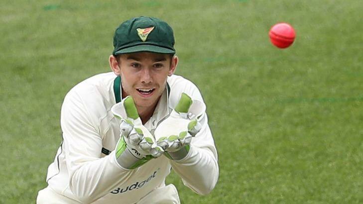Tasmanian wicketkeeper Jake Doran with the new pink ball in use in the Sheffield Shield match at the MCG on Tuesday. Photo: Scott Barbour