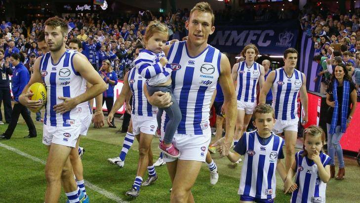 North Melbourne's Drew Petrie is acompanied by his children as he takes the field for his 300th game. Photo: Michael Dodge