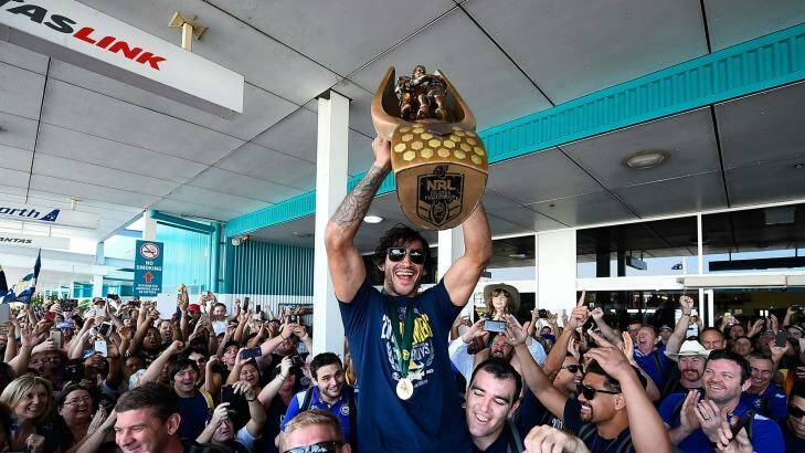 TOWNSVILLE, AUSTRALIA - OCTOBER 05:  Johnathan Thurston of the Cowboys is hoisted onto the shoulders of Ben Hannant and Kane Linnett with the NRL trophy after arriving back at the Townsville airport before heading out to  the North Queensland Cowboys NRL Grand Final fan day at 1300 Smiles Stadium on October 5, 2015 in Townsville, Australia.  (Photo by Ian Hitchcock/Getty Images) Photo: Ian Hitchcock