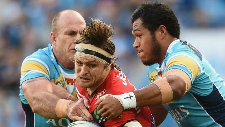 Mitch Rein of the Dragons takes on the Titans defence at Cbus Super Stadium on the Gold Coast. Photo: Matt Roberts