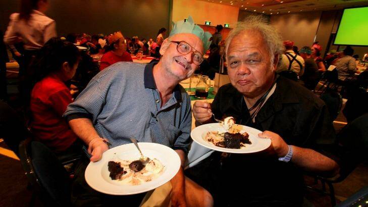 Steven Koop, from Acacia Ridge, and Kenny Lynn, from Woolloongabba, enjoy the pudding served at the annual Salvation Army Christmas lunch at the Brisbane Convention and Exhibition Centre. Photo: Michelle Smith