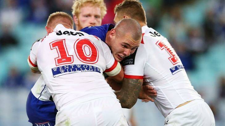 Collision: David Klemmer is tackled by the Dragons defence. Photo: Brendon Thorne