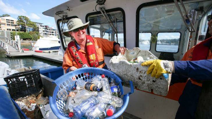 Clean Up Australia Day volunteers battle the bottle scourge in Sydney's waterways in March this year. Photo: Peter Rae
