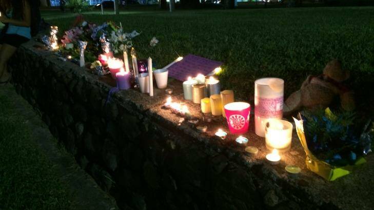 Candles lit in tribute to eight children who were killed at a home in Cairns. Photo: Cameron Atfield