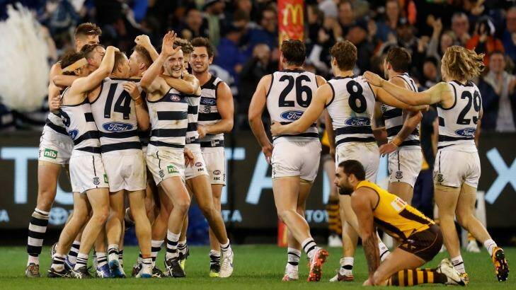 Close call: Geelong players celebrate after Isaac Smith's after-the-siren attempt at goal for the Hawks went wide. Photo: AFL Media/Getty Images