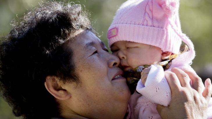 A Chinese woman plays with her grandchild at Ritan Park in Beijing. Photo: Andy Wong
