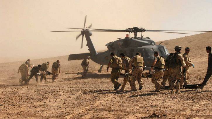 Australian and Afghan troops  evacuate civilian victims of a Taliban roadside bomb in Uruzgan Province, Afghanistan.