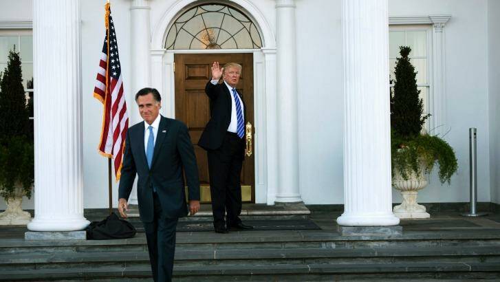 President-elect Donald Trump waves goodbye to Mitt Romney after they met at the Trump National Golf Club. Photo: New York Times