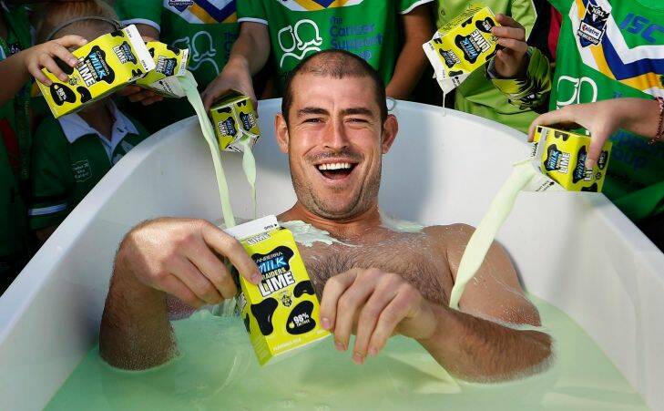 Sunday Times: Canberra Raiders fans help give Canberra Raiders captain Terry Campese a bath of Raiders Lime during the members day at Canberra Stadium. 23 March 2013. Canberra Times Photograph by Jeffrey Chan