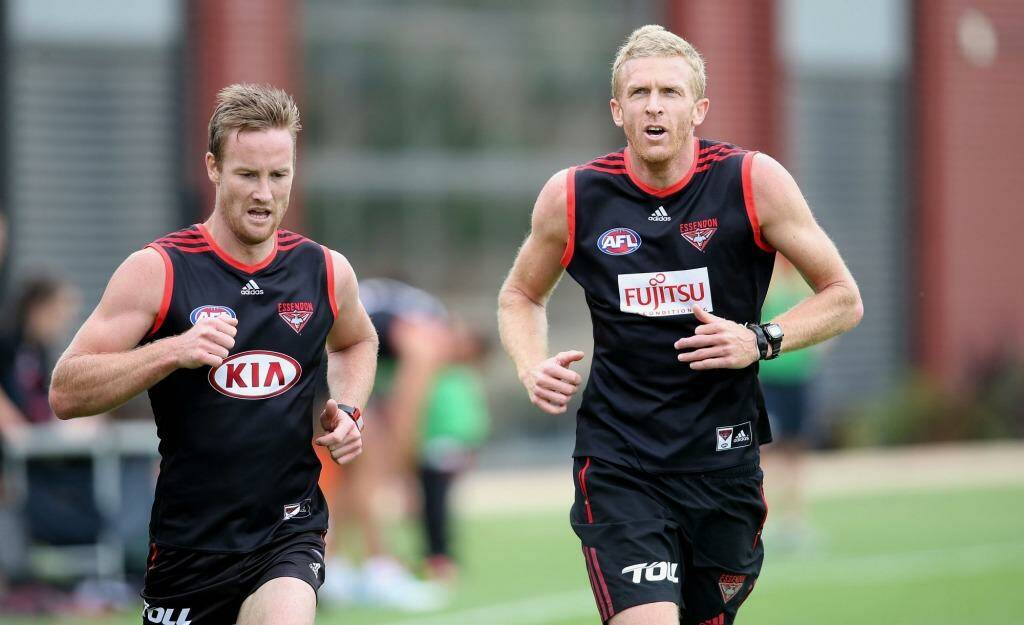 Dustin Fletcher (right), preparing for a remarkable 23rd season, is still seen as a vital piece in defence, while the clever Jason Winderlich (left) had a strong 2014 and made the right call to play on. Photo: Pat Scala