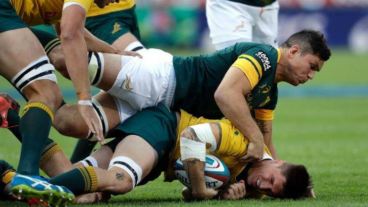 Australia's Sean McMahon, on ground, is tackled by South Africa's Francois Louw. Photo: THEMBA HADEBE