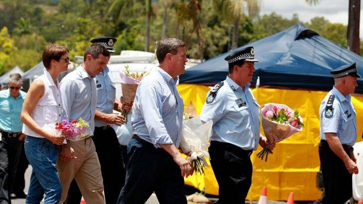 Acting Premier Tim Nicholls and senior police walk past the Cairns house where eight children died. Photo: Edwina Pickles