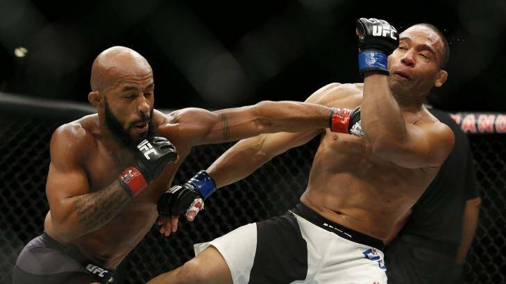 Demetrious Johnson hits John Dodson during their flyweight title mixed martial arts bout at UFC 191, Saturday. Photo: John Locher