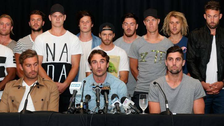 Watson is flanked by teammates as he addreses the media after the Essendon 34 were initially cleared by the AFL anti-doping tribunal. Photo: Quinn Rooney