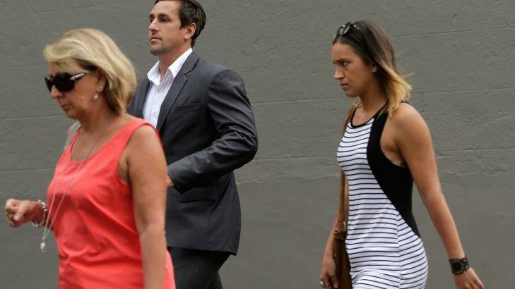 Mitchell Pearce arrives to speak at a press conference in Surry Hills on Friday with his mother Terri, left, and sister Tatum, right.