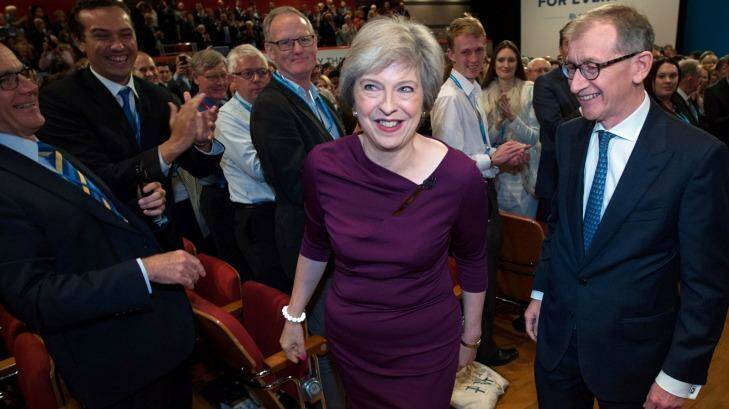Theresa May and her husband, Philip John May, leave the Birmingham conference hall to a standing ovation. Photo: Stefan Rousseau