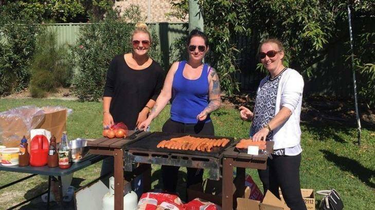 (From left): Shelby Callinan, Kylie Rolley, Saasha Aplin, cooking up a sausage sizzle to feed the community. Photo: Nerang RSL & Memorial Club/Faceb