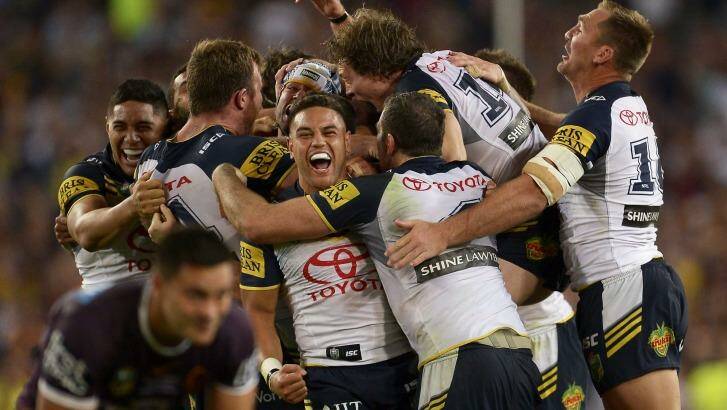 The Cowboys players celebrate their victory - and Johnathan Thurston emerged with a gash above his eye.  Photo: Brett Hemmings