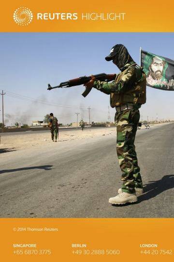 Checkpoint: A Badr Brigade militia guard on a road outside Amerli. Photo: Ahmed Jadallah