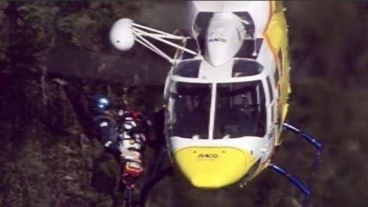 The RACQ rescue helicopter has winched the injured 18-year-old woman off Mount Tibrogargan. Photo: Nine News Brisbane
