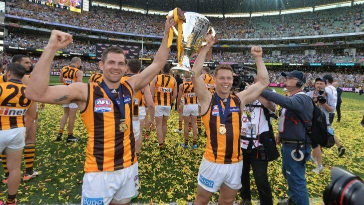 Old stagers: Luke Hodge and Sam Mitchell hold up the premiership cup Photo: Joe Armao