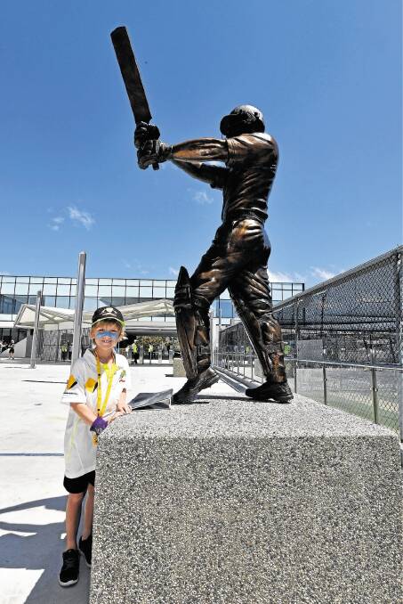 Angus Thomas, 7, of Melbourne, looks at the new Ricky Ponting statue. Picture: SCOTT GELSTON