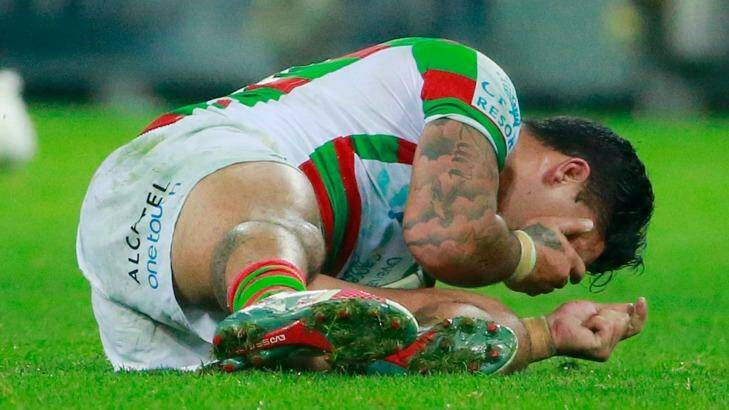Issac Luke holds his head after being kicked by Cameron Smith.  Photo: Scott Barbour