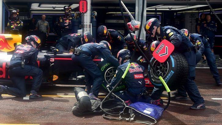 Victory ebbs away as technicians change Ricciardo's tyres. Photo: Andrej Isakovic/AP