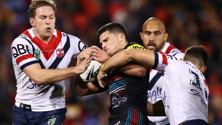 Sandwiched: The Roosters defence latches onto Panthers rookie Nathan Cleary. Photo: Brendon Thorne