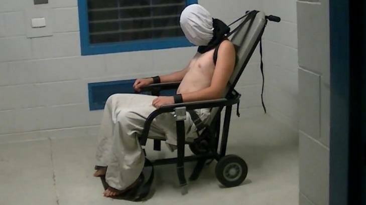 Dylan Voller is hooded and strapped to a restraining chair in the footage aired on Four Corners.  Photo: ABC Four Corners