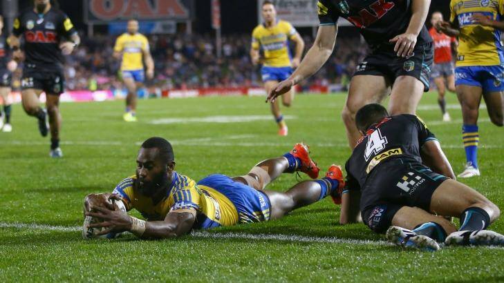Touch down: Semi Radradra of the Eels dives over to score.  Photo: Mark Kolbe