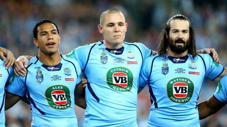 Brothers in arms: David Klemmer and Aaron Woods sing the national anthem with Will Hopoate before game one of the 2015 State of Origin series. Photo: Mark Kolbe