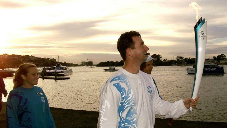 Seoul Olympic gold medalist Duncan Armstrong at the Brisbane River during the Sydney 2000 torch relay. Photo: Greg Garay