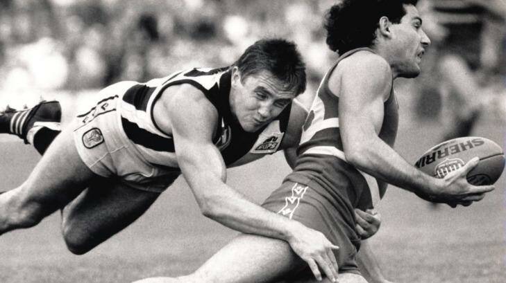 Collingwood's Tony Shaw makes a flying tackle on Footscray's Angelo Petraglia at a game in 1986.