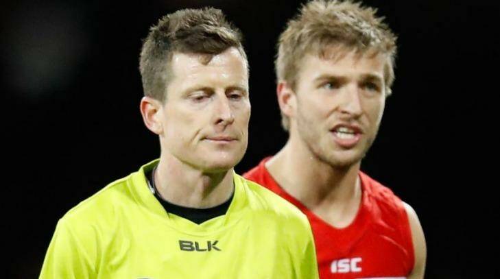 Kieren Jack speaks with umpire Chris Donlon during the Swans' match against Hawthorn. Photo: Getty Images/AFL Media