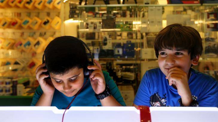 At the shops: two boys listen to music in a store at Baghdad's Mansour Mall. Photo: Kate Geraghty