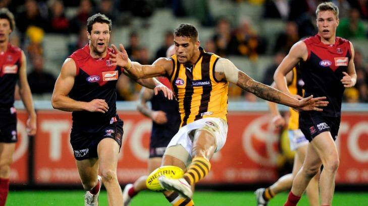 Much has changed since Melbourne's last Friday night game, as shown by the colours worn by Lance Franklin and James Frawley respectively. Photo: Sebastian Costanzo