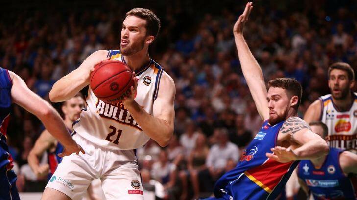Eric Jacobsen of the Adelaide 36ers is pushed out of the way by Jarred Baristow of the Brisbane Bullets. Photo: Morne de Klerk