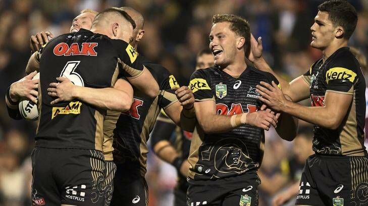 Leapfrog into sixth spot: Peter Wallace celebrates scoring a try with Panthers teammates. Photo: Brett Hemmings