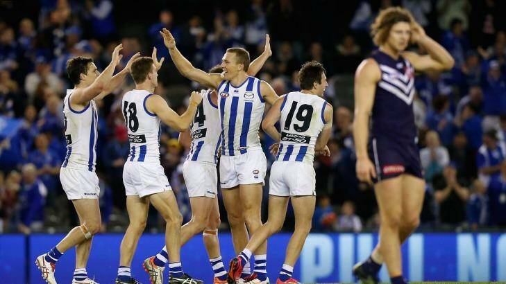 Threatening: The Kangaroos celebrate their victory over the top-placed Dockers on Sunday. Photo: AFL Media/Getty Images
