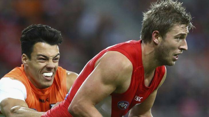 Caught: Kieren Jack of the Swans is tackled by Dylan Shiel.