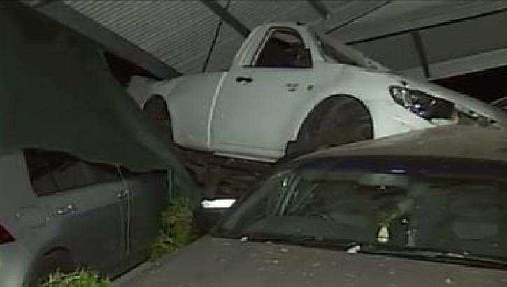 A ute has slammed into a residential carport in Holland Park on Sunday morning, landing on top of two other cars and causing the structure to collapse. Photo: 7 News Sydney