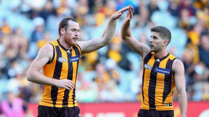 Forward march: Jarryd Roughead is congratulated by Hawks teammate Luke Breust after kicking a goal against the Melbourne Demons at the Melbourne Cricket Ground last Saturday. Photo: Quinn Rooney