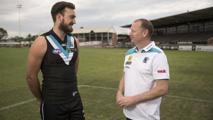 Charlie Dixon with Port Adelaide coach Ken Hinkley at Alberton Oval in Adelaide on Wednesday. Photo: David Mariuz