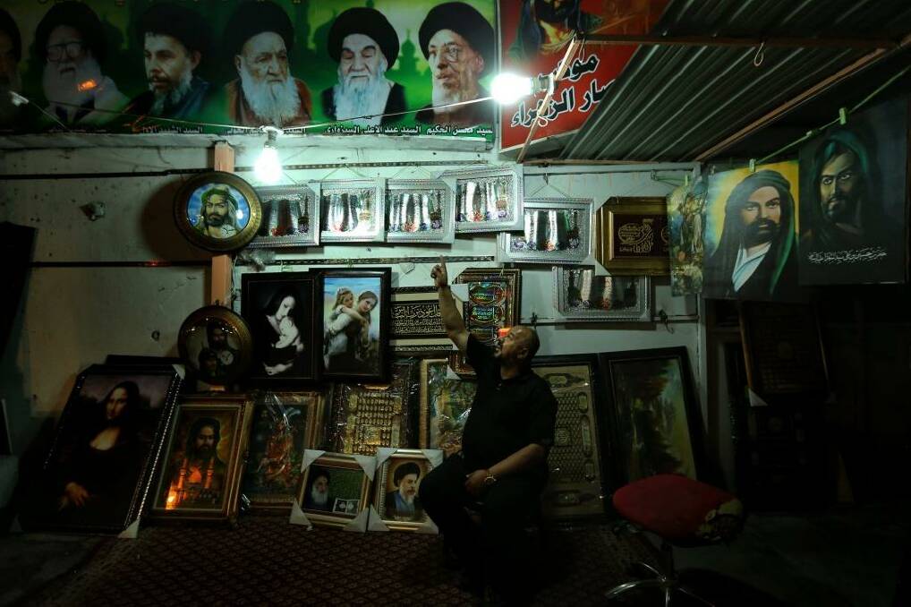 'I got lucky': Mohammed Khaddum sits among religious merchandise at his stall in Karrada. Photo: Kate Geraghty