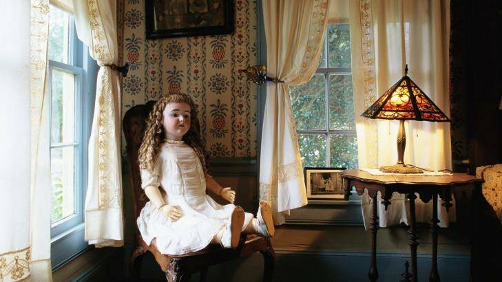 A house in the Millard's Crossing Historic Village displays an antique doll in a sitting room. 