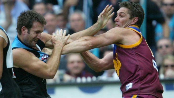 Alastair Lynch (right) tangles with Port Adelaide's Darryl Wakelin during the 2004 grand final. Photo: Vince Caligiuri