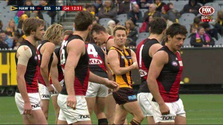 Hawthorn's Sam Mitchell taunts Essendon players, by feigning giving himself an injection. Photo: Fox Footy