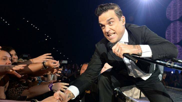 Robbie Williams interacts with  ecstatic members of the crowd in Brisbane. Photo: Bradley Kanaris